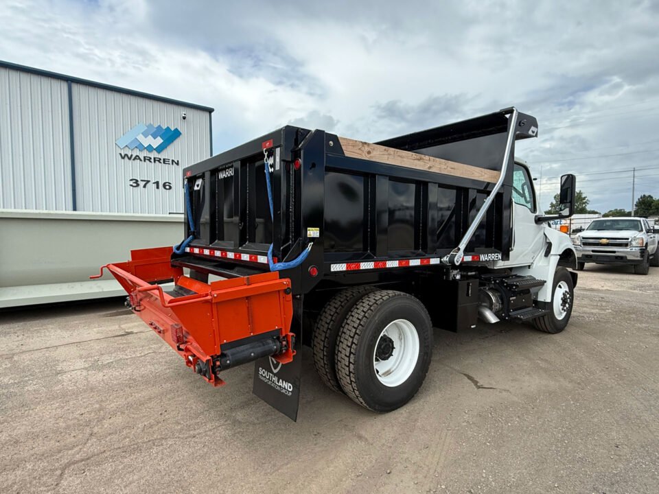 Warren F-10 dump body paired with AC-1820 cross conveyor on a jobsite