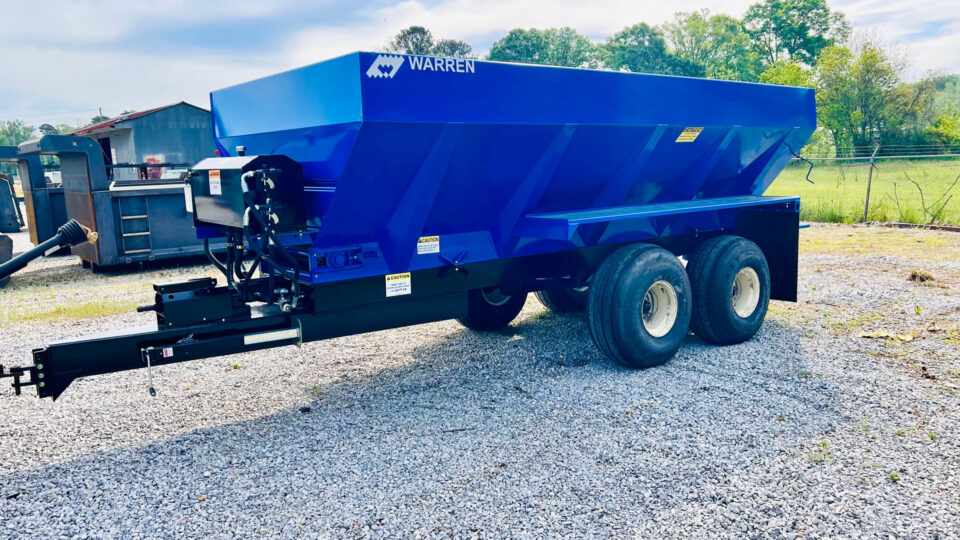 Warren Litter Spreader spreading material across farmland